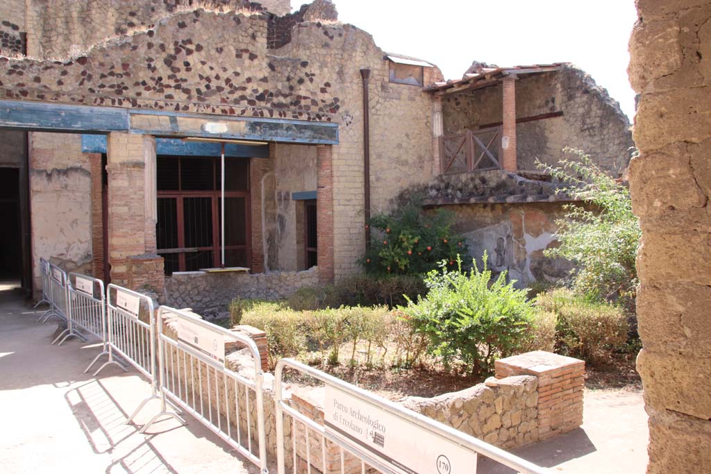 III.11 Herculaneum. September 2019. Looking south-east from north portico towards doorway to tablinum 9, and room 8.   
On the right, is the rear of III.14. Photo courtesy of Klaus Heese.